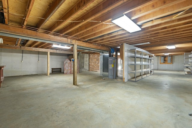 basement featuring electric water heater and electric panel