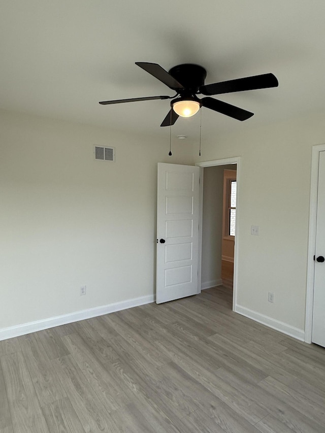 unfurnished bedroom with ceiling fan and light hardwood / wood-style flooring