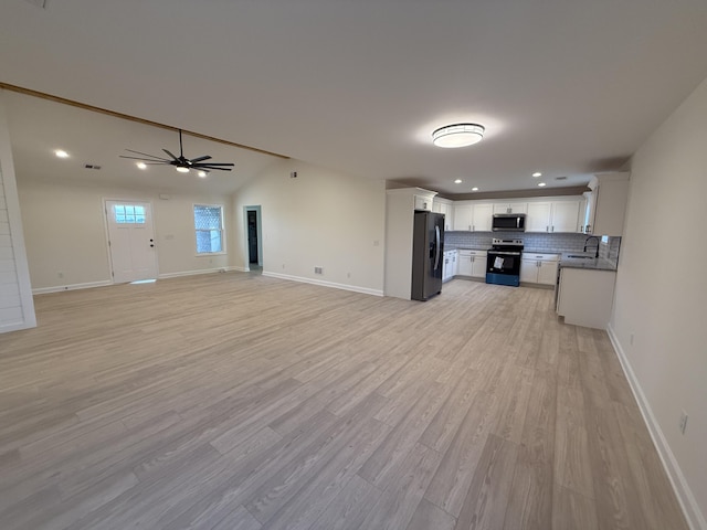 kitchen with white cabinetry, sink, stainless steel appliances, and light hardwood / wood-style flooring