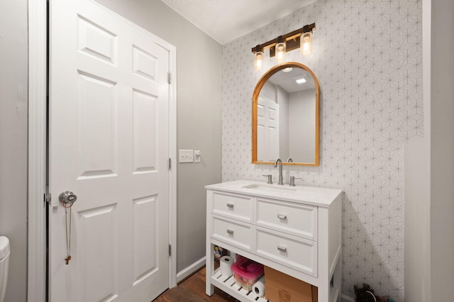 bathroom featuring vanity, a textured ceiling, and hardwood / wood-style flooring