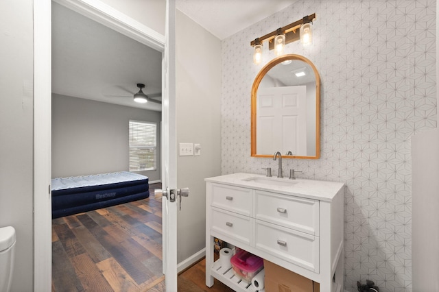 bathroom with ceiling fan, vanity, and wood-type flooring