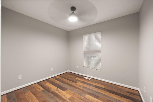 unfurnished room with hardwood / wood-style flooring