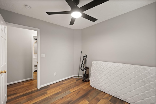 unfurnished bedroom with ceiling fan and dark hardwood / wood-style floors