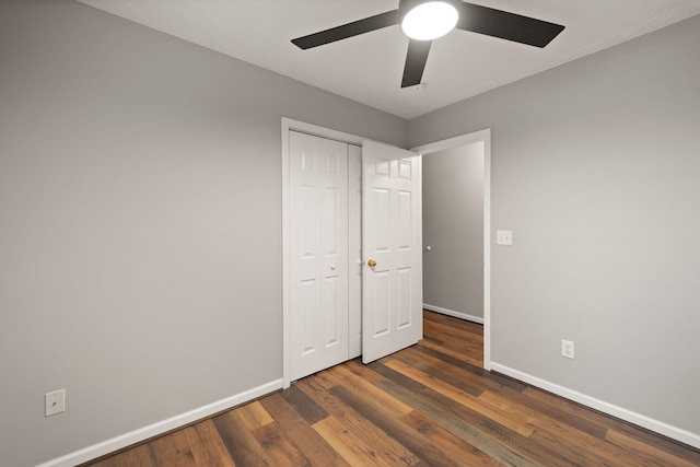 unfurnished bedroom with a closet, ceiling fan, and dark hardwood / wood-style flooring