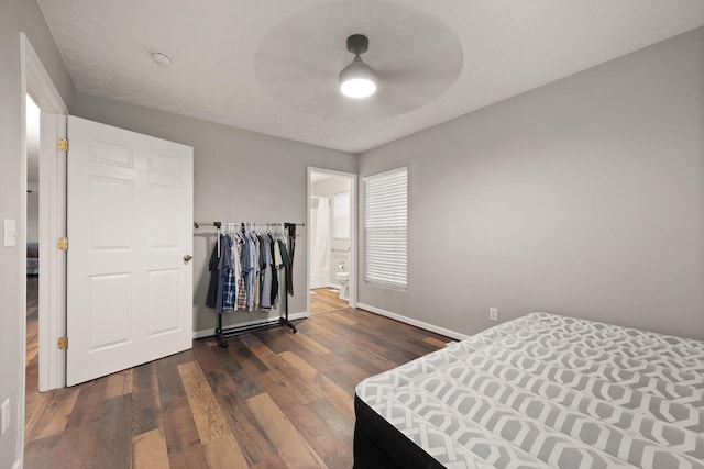 bedroom with dark hardwood / wood-style floors and ceiling fan