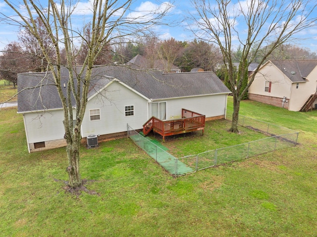 back of property with a deck, central AC unit, and a lawn