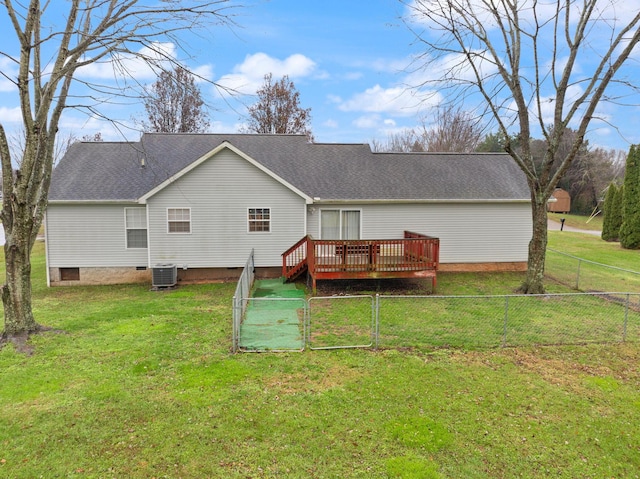 rear view of property featuring central air condition unit, a wooden deck, and a yard