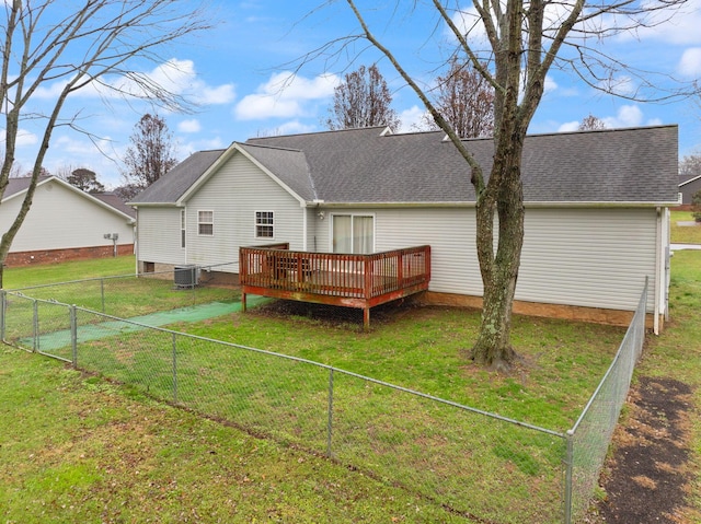 rear view of house with a wooden deck, a yard, and central AC unit