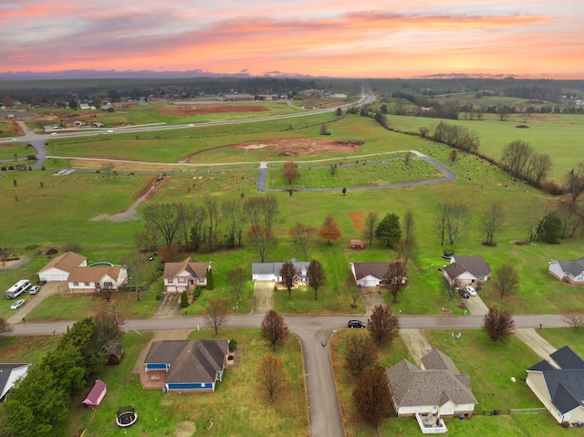 aerial view at dusk featuring a rural view