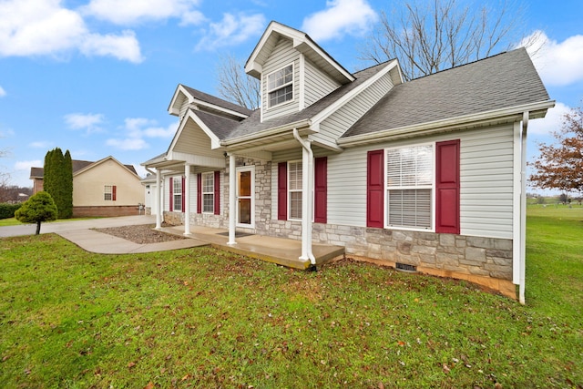 cape cod home with a front lawn