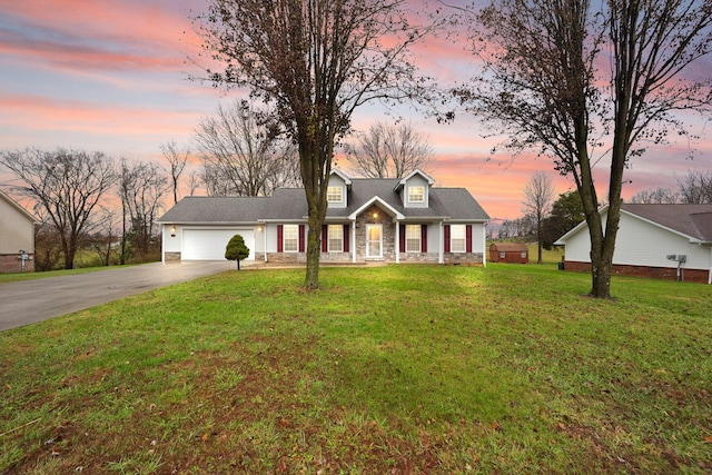 cape cod-style house with a garage and a lawn