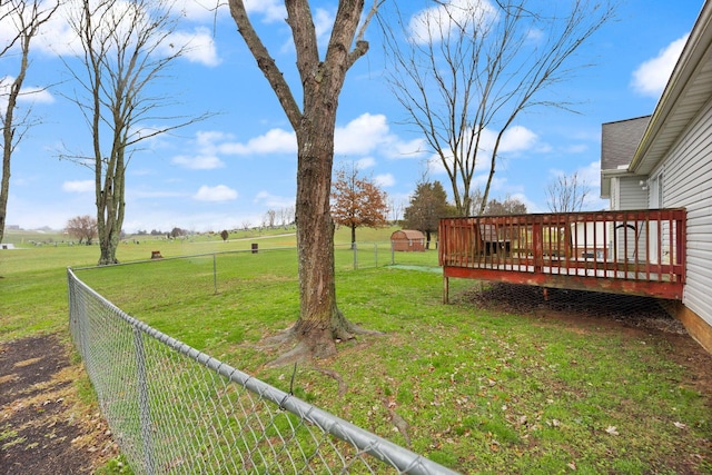 view of yard with a rural view and a wooden deck