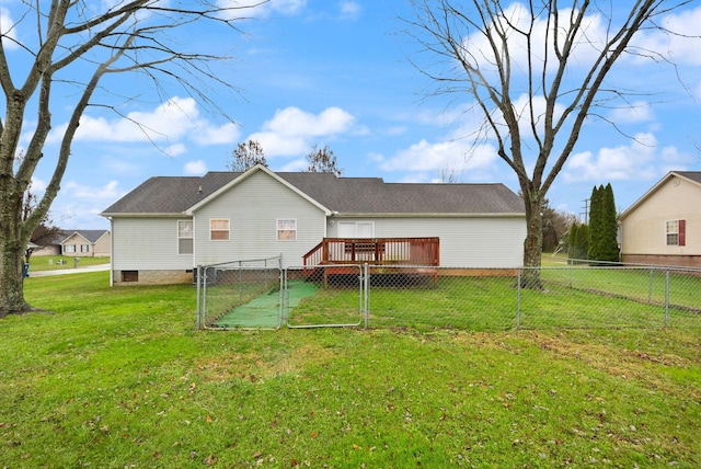 rear view of property featuring a lawn and a wooden deck