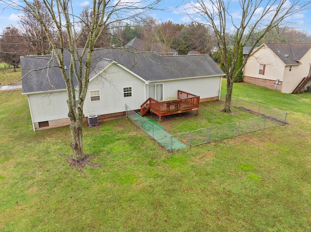 rear view of property with a lawn, a deck, and central air condition unit