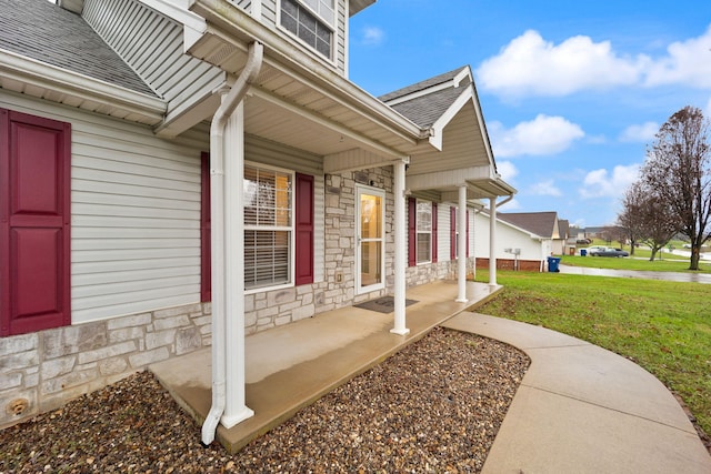 exterior space featuring a porch and a yard