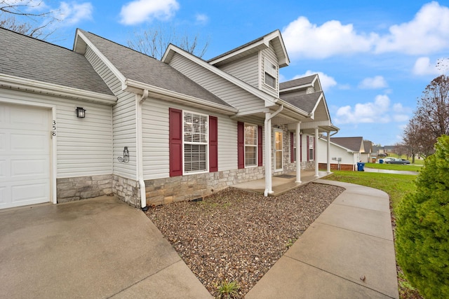 exterior space featuring covered porch and a garage