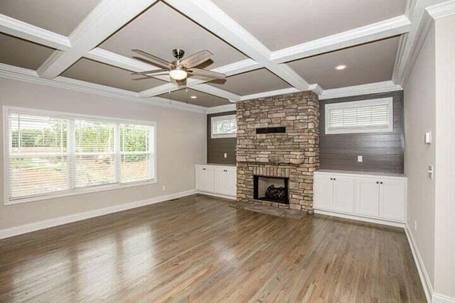 unfurnished living room with coffered ceiling, a fireplace, dark hardwood / wood-style floors, and ornamental molding