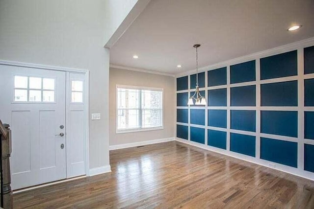 foyer entrance featuring ornamental molding and hardwood / wood-style flooring