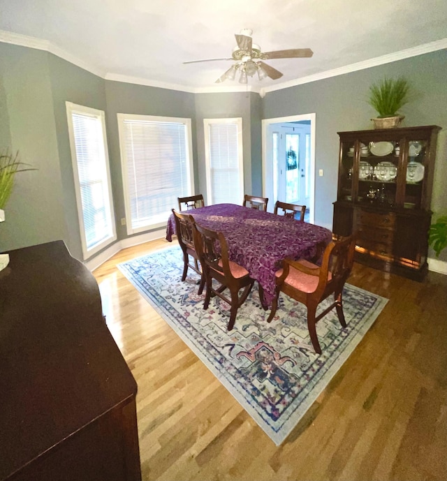 dining area with crown molding, hardwood / wood-style floors, and ceiling fan