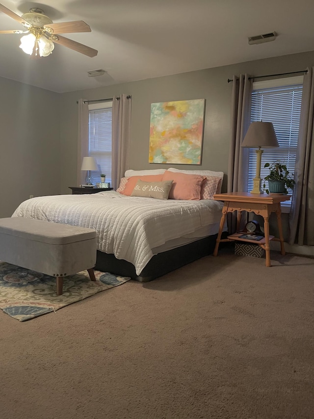 bedroom with ceiling fan and carpet floors