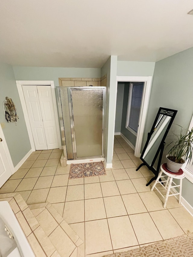 bathroom with tile patterned flooring and a shower with door