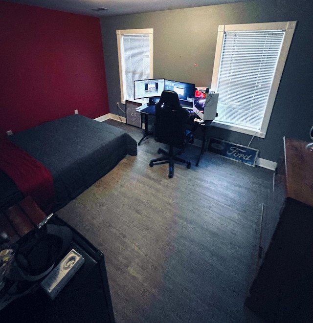 bedroom with dark hardwood / wood-style floors