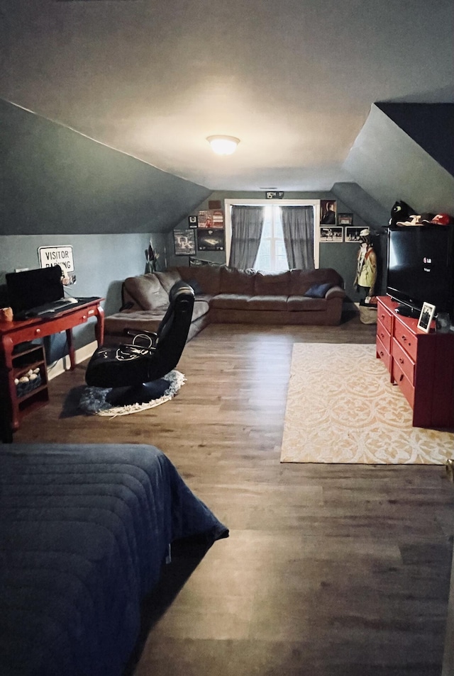 bedroom featuring wood-type flooring and lofted ceiling