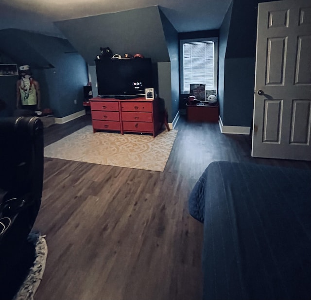 bedroom featuring dark hardwood / wood-style floors and vaulted ceiling