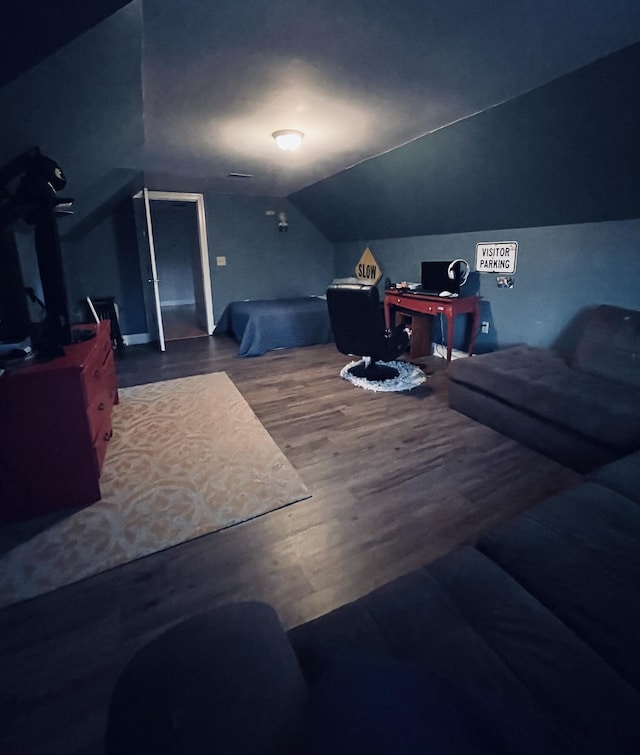 bedroom featuring hardwood / wood-style floors and vaulted ceiling