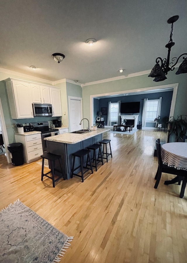 kitchen featuring light hardwood / wood-style floors, white cabinetry, and appliances with stainless steel finishes