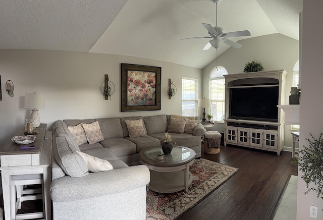 living room featuring ceiling fan, dark wood-type flooring, and vaulted ceiling