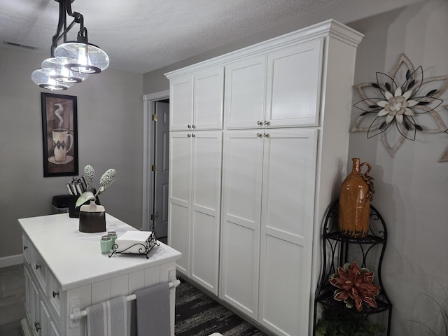 interior space with a textured ceiling and hardwood / wood-style flooring