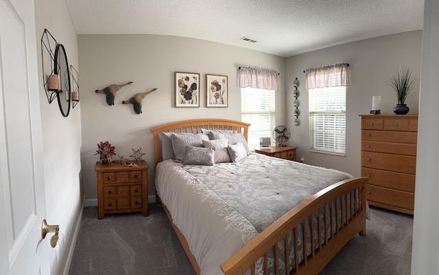 carpeted bedroom featuring a textured ceiling