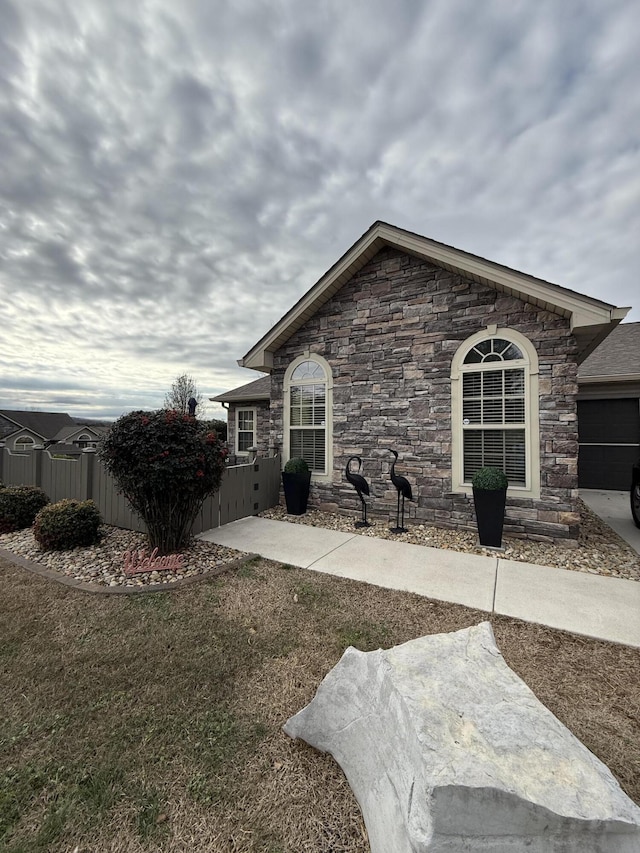 364 Cathedral Pl, Bronston, KY 42518 - view of front facade with fence, a front lawn, and stone siding