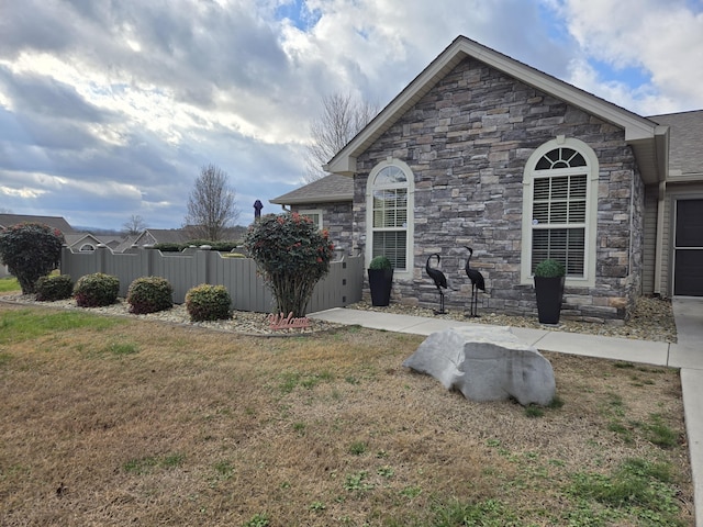 view of side of home featuring a yard