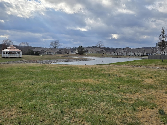 view of yard with a gazebo and a water view