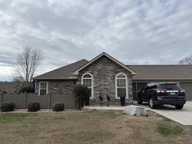 364 Cathedral Pl, Bronston, KY 42518 - ranch-style house with concrete driveway, stone siding, a front yard, an attached garage, and fence