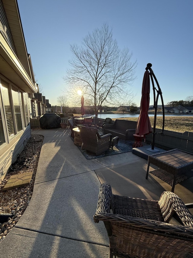 view of patio / terrace with a water view and an outdoor living space with a fire pit