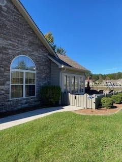 view of property exterior featuring a lawn