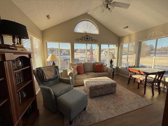 sunroom with ceiling fan and vaulted ceiling