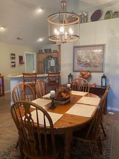 dining room with parquet flooring and a notable chandelier