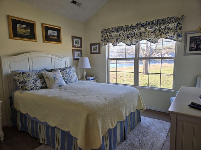 bedroom featuring wood-type flooring and vaulted ceiling