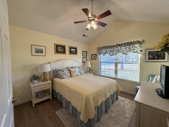 bedroom featuring dark wood-type flooring, ceiling fan, and vaulted ceiling