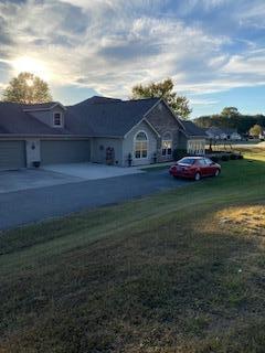 ranch-style home featuring a garage and a front yard