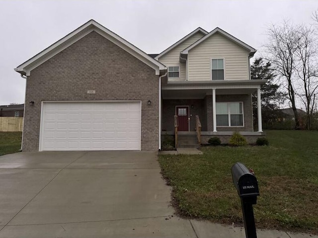 view of front of home featuring a garage, covered porch, and a front lawn