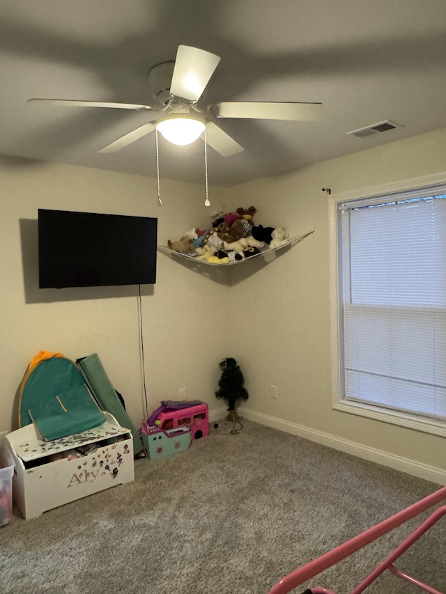 rec room featuring carpet flooring and ceiling fan