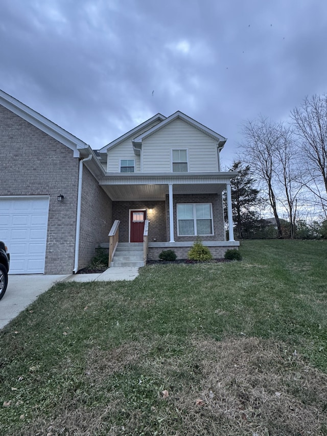 view of front of property with a front lawn, covered porch, and a garage