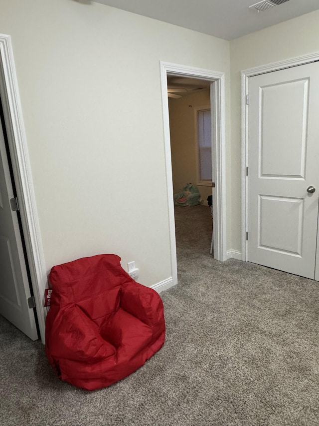 sitting room with carpet flooring