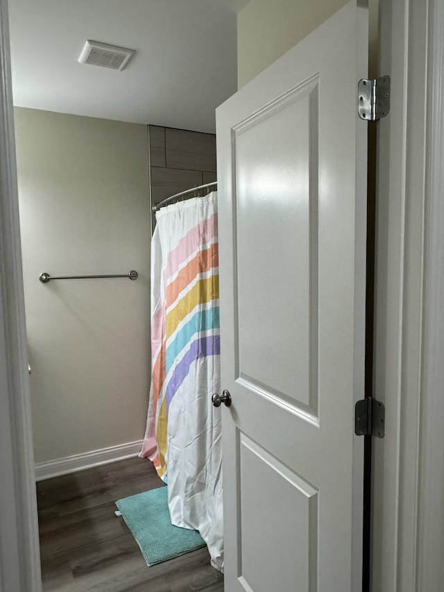 bathroom with wood-type flooring