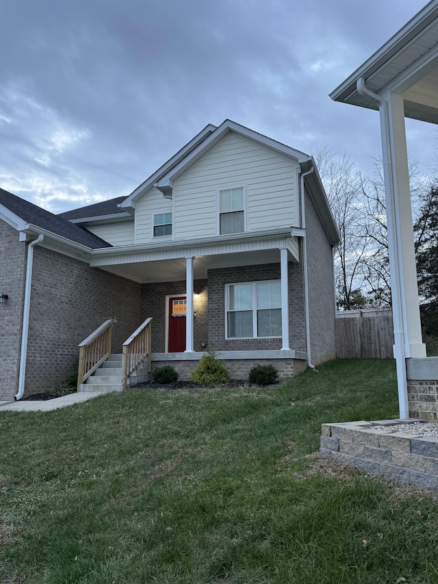 view of front property with covered porch and a front lawn